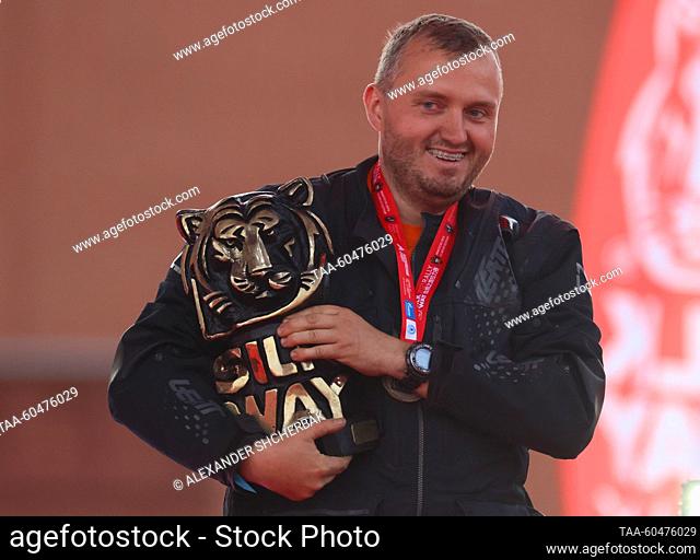 RUSSIA, MOSCOW - JULY 15, 2023: Rider Dmitry Kalinin celebrates his trophy as he wins the G-moto/quad first prize during a ceremony to finish the 2023 Silk Way...