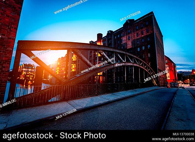 Poggenmuehlen Bridge at dawn. Hamburg, Germany. illuminated buildings and last sunrays. Warehouse District Speicherstadt Landmark of HafenCity quarter
