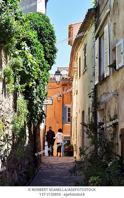 Europe, France, Var. Ramatuelle. Couple walking in a typical alley in the village