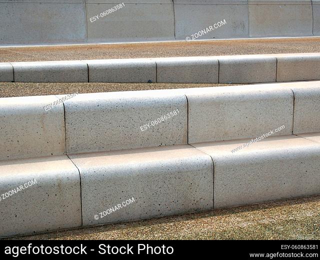 modern angled outdoor steps with rounded corners int textured grey and brown colors