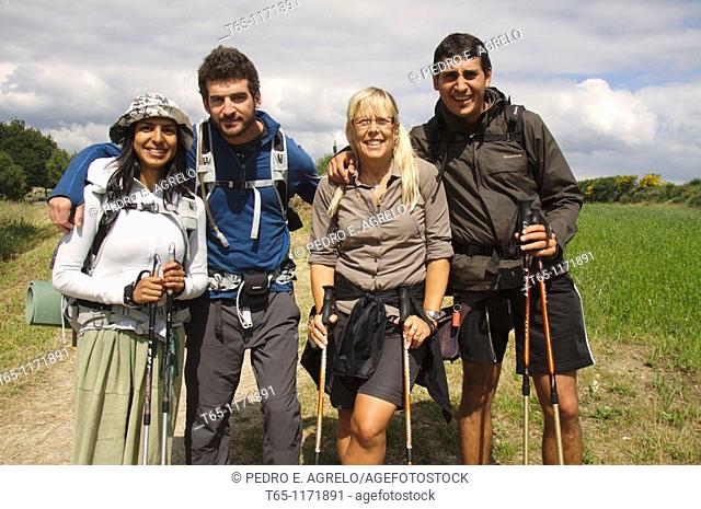 Pilgrims of different nationalities have a picture taken as a memento in his journey along the Camino de Santiago. Sarria, Province of Lugo, Galicia, Spain