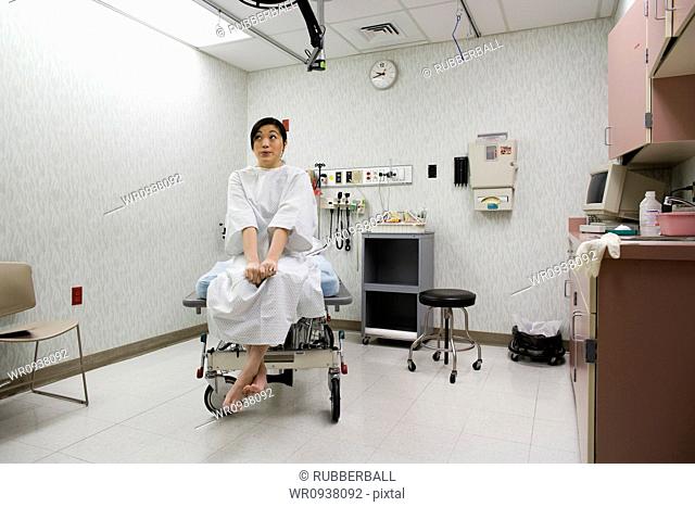 Female patient waiting anxiously in examining room