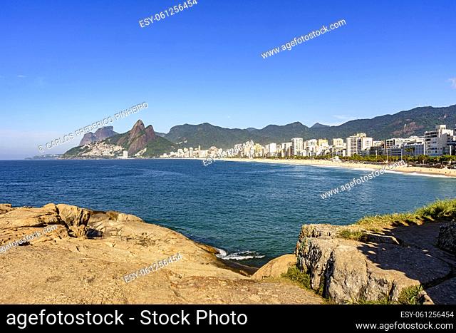 Panorama of Ipanema beach in Rio de Janeiro on a beautiful day with the sea, buildings and hills around in the morning