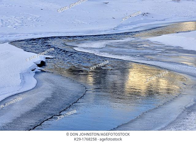 Lamar river with snow drifts in late winter, Yellowstone NP, Wyoming, USA