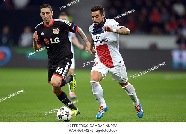 Leverkusen's Roberto Hilbert (L) and St. German's Ezequiel Lavezzi vie for the ball during the Champions League last round of sixteen match between Bayer 04...