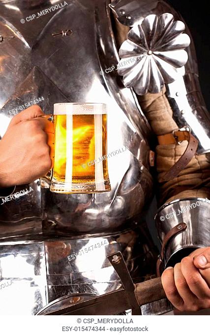knight wearing armor and holding mug of beer and two-handed swor