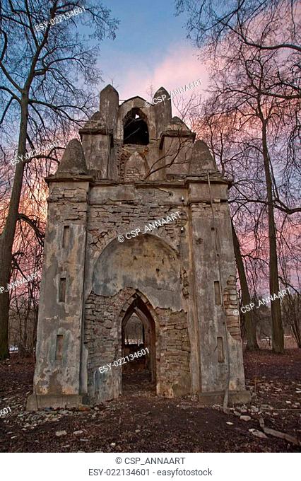 The old ruined arch in the Gothic style in Russia in the ruined manor