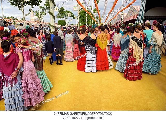 Young female students dressed in flamenco dresses at the April Fair in Seville