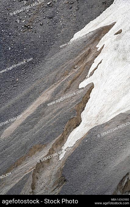 Scree and gravel on the mountain slope of the Eastern Karwendelspitze, last remnants of snow fill a gully