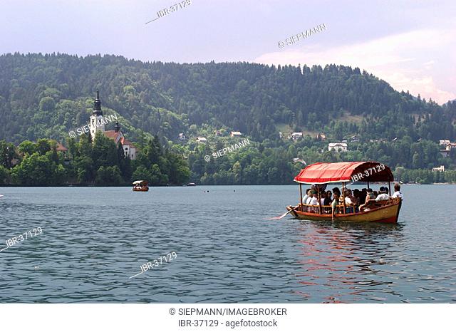 Lake Bled with boat and island Otok - Slovenia - glacial lake in the extreme northwestern region of Slovenia, situated northwest of Ljubljana