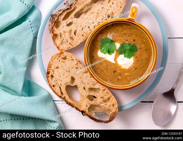 Vegetable soup with bread slices - Top view photo on white table