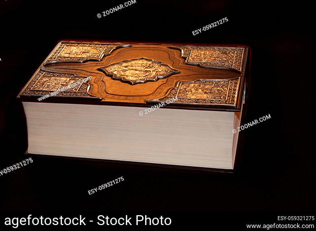 Ancient book in luxurious binding isolated on black background. Old book. Closed book on dark background
