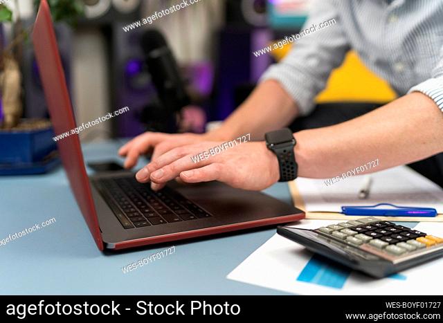 Businessman using laptop while working at home office