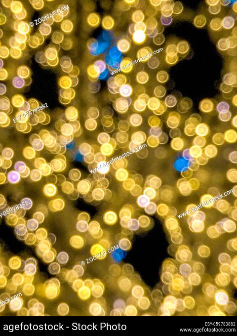 Blurred mass of yellow and some blue twinkle lights at night