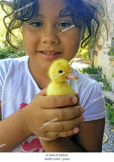 Little girl with duckling