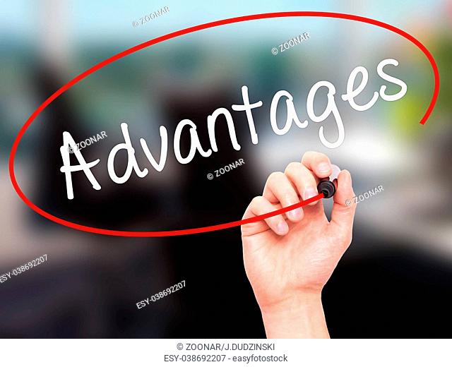 Man Hand writing Advantages with black marker on visual screen