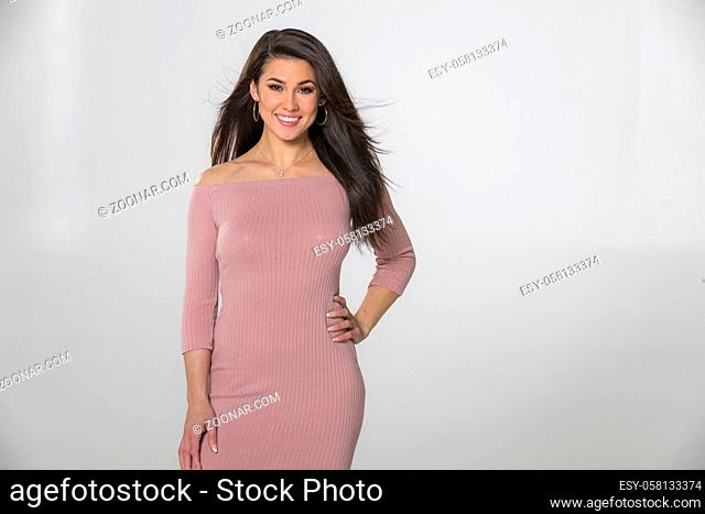 A gorgeous brunette model posing in a studio environment