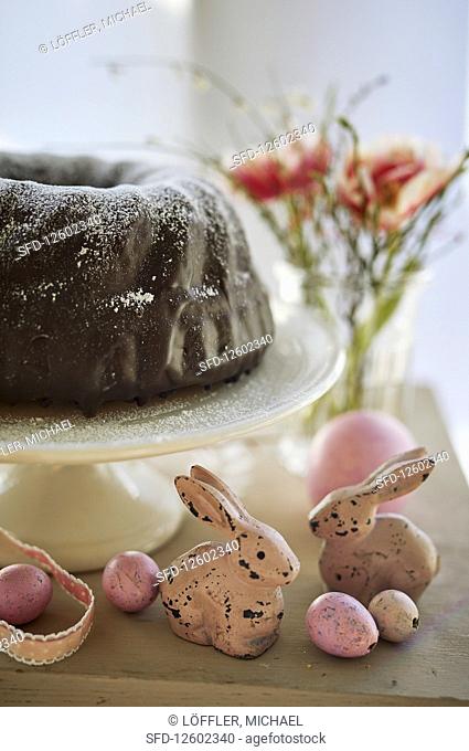 Bundt cake with chocolate glaze and Easter decorations
