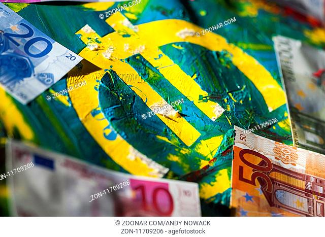 Euro-Zeichen in bunter pastös vermischter Acryl-Farbe mit aufgelegten Euro-Banknoten. Euro-Zeichen in bunter pastös vermischter Acryl-Farbe mit aufgelegten...