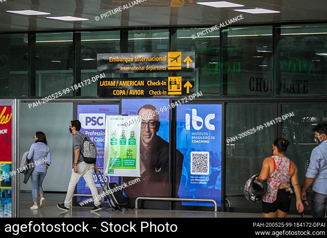 25 May 2020, Brazil, Manaus: Travelers go to the international boarding area at Eduardo Gomes International Airport. In view of the rapidly increasing number of...