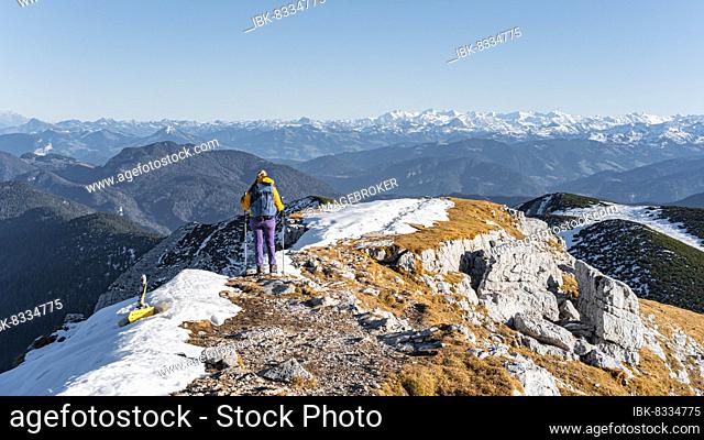 Climber walking along mountain ridge, snow-covered mountains, hiking to Guffert, Brandenberg Alps, Tyrol, Austria, Europe