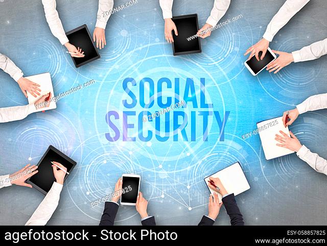 Group of people in front of a laptop with SOCIAL SECURITY insciption, web security concept