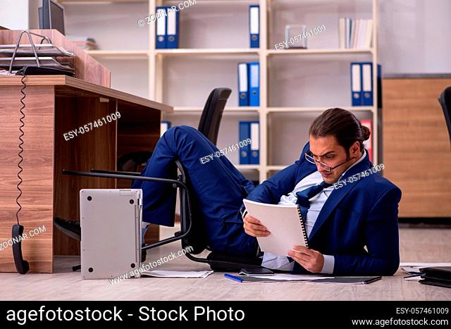 Young businessman employee unhappy with his work in the office