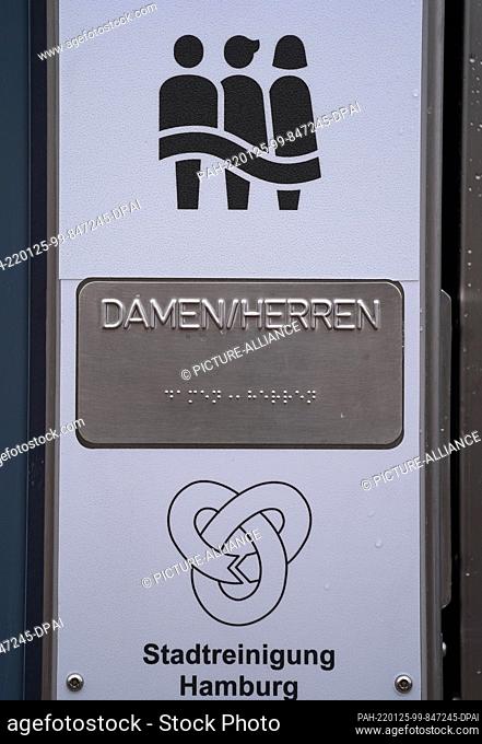 25 January 2022, Hamburg: A gender-equitable logo (above) and the words ""Ladies/Gentlemen"" stand at the entrance to the gender-equitable toilet in front of...