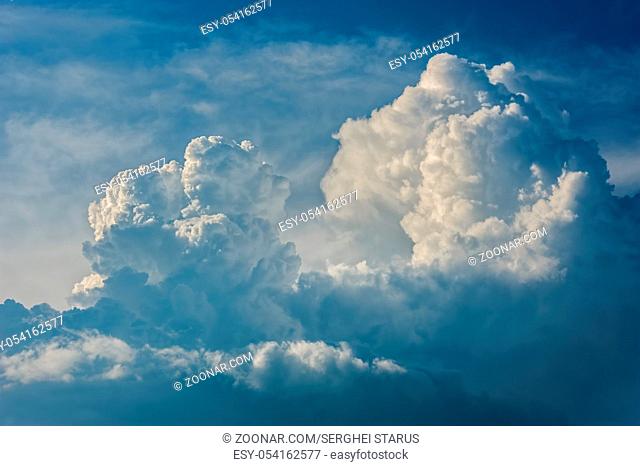 Large fluffy cloud relief details on blue sky