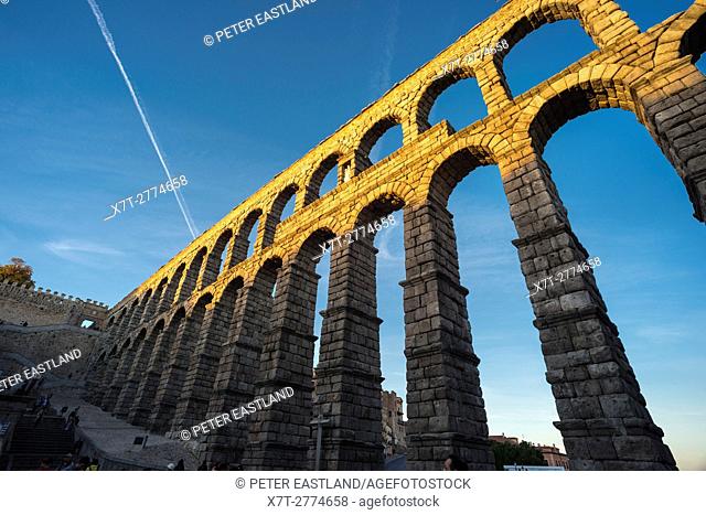 Late evening sunlite on Segovia's 1st century Roman Aqueduct in the Plaza Azuguejo, Segovia, Spain