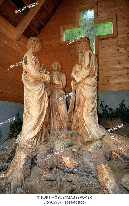 Carved sculptures, made out of a living swiss pine (Pinus cembra), group Holy Family in the swiss pine, Suppanalm, Schoenfeld, Lungau, province Salzburg