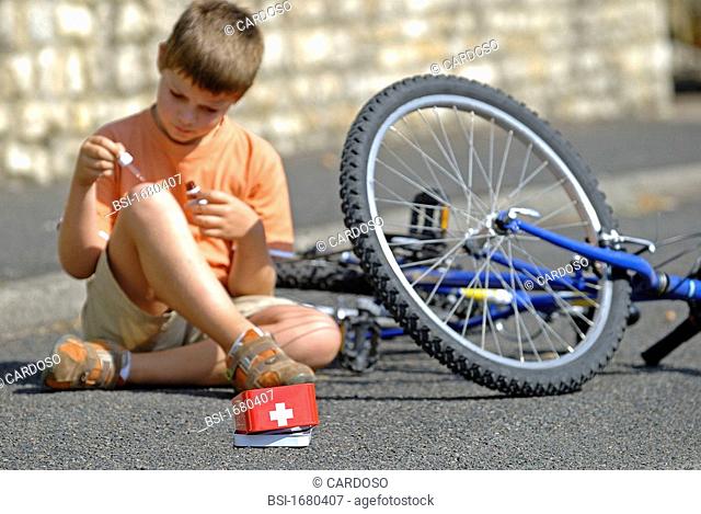 WOUND CARE, CHILD Model. Disinfection of a wound after falling off the bike