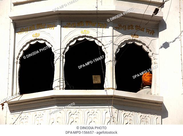 Sikh devotee sitting in the upper floor of the backyard of Sachkhand Saheb Gurudwara in Nanded ; Maharashtra ; India
