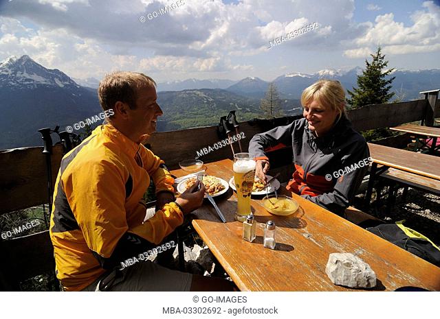 hikers eat in the Mittenwalder hut, Upper Bavaria, Germany