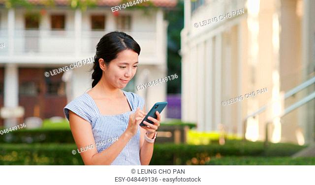 Woman use of mobile phone at the street