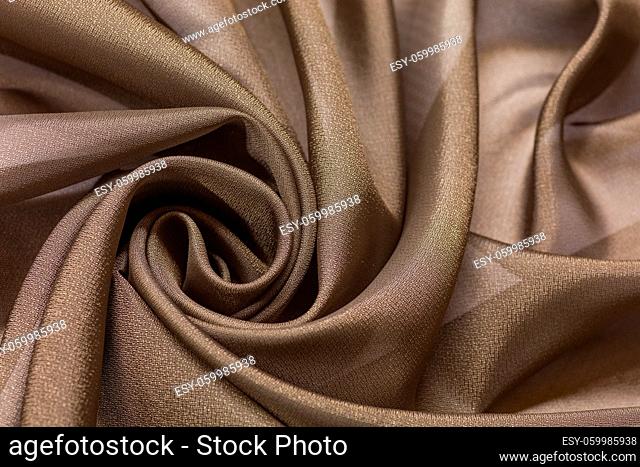 Shiny cloth background with beige vail textile