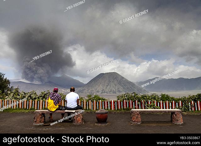 Two Tourists Watching A Mt Bromo Eruption, Bromo Tengger Semeru National Park, Java, Indonesia