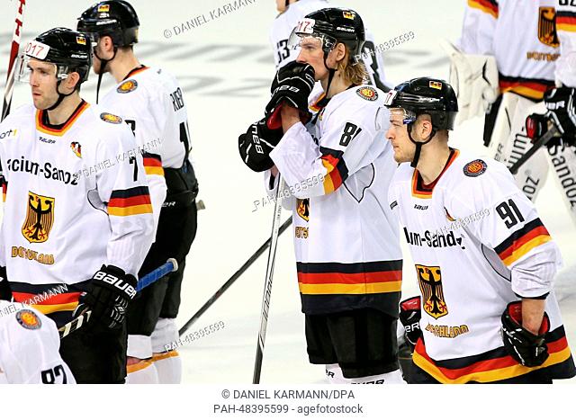 Germany's Daryl Boyle (L-R), Tobias Rieder, Torsten Ankert and Moritz Mueller look dejected after the 1-3 defeat in the ice hockey world cup friendly match...
