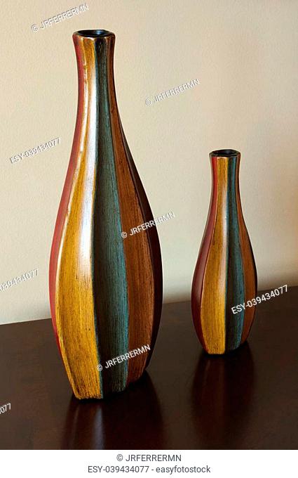 Two wooden vases standing on table