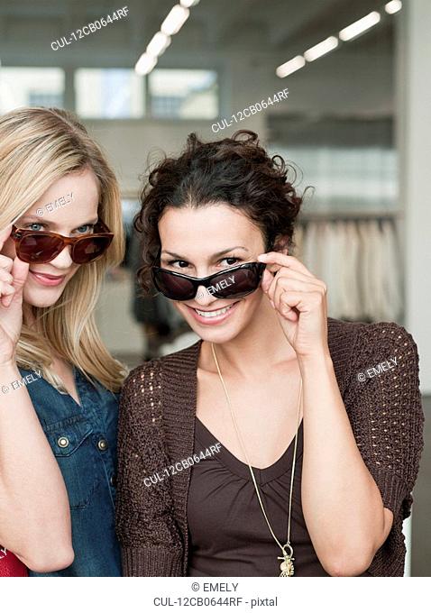 women shopping trying sunglasses