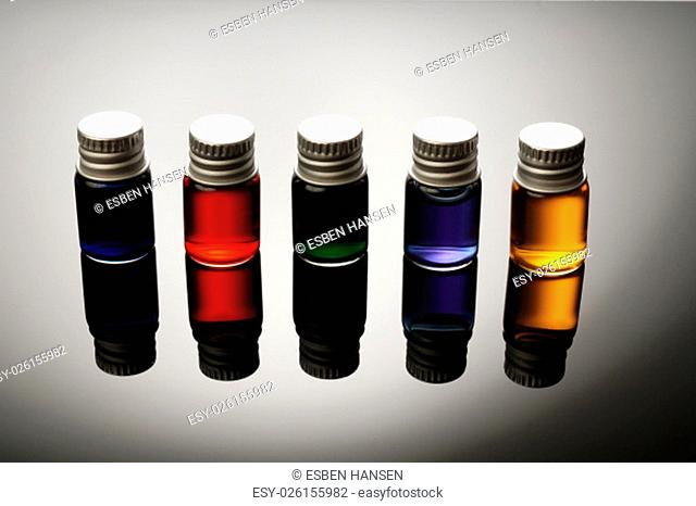 Five Colorful vials isolated on black background