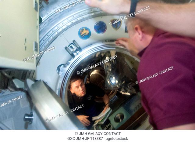 Russian cosmonaut Oleg Novitskiy (right), Expedition 34 flight engineer, prepares to close the hatch between the Soyuz 31 (TMA-05M) and the International Space...