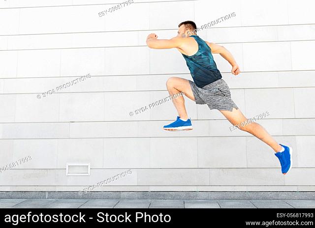 young man running or jumping outdoors
