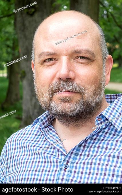 An image of a handsome bearded man portrait outdoors