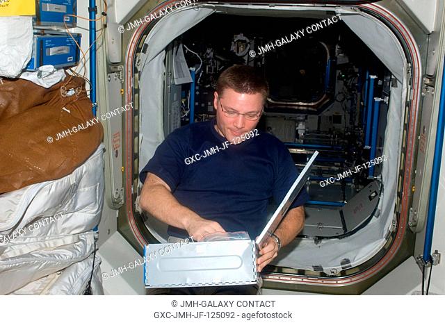 NASA astronaut Doug Wheelock, Expedition 25 commander, makes a beverage selection in the Harmony node of the International Space Station