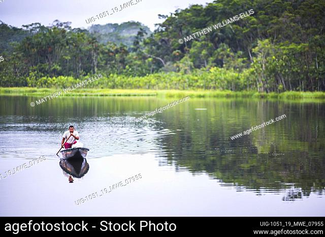 Dugout canoe boat ride in an Amazon Rainforest Lagoon at Sacha Lodge, Coca, Ecuador, South America