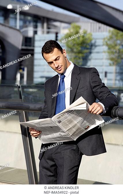A businessman reading the paper on the airport, Denmark