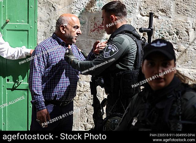 18 May 2023, ---, Jerusalem: An Israeli security officer urgues with a man in Jerusalem Old City ahead of Jerusalem Day, an annual event during which Israeli...