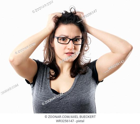 anxious stressed young woman tearing her hair out