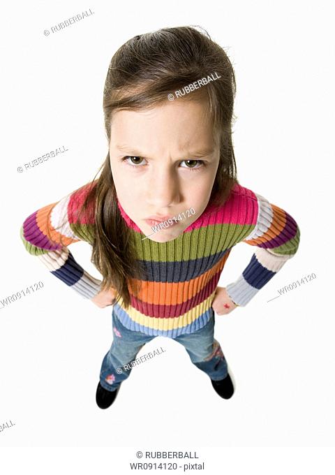 Young girl with irritated look and hands on hips